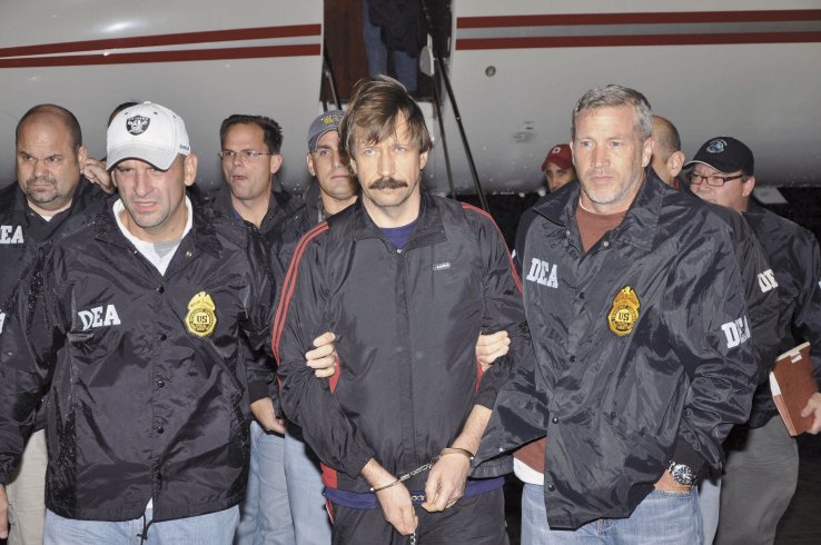 Russian arms trafficker Viktor Bout, centre, arrives in the United States in November 2010 to face trial, having been extradicted from Thailand. 